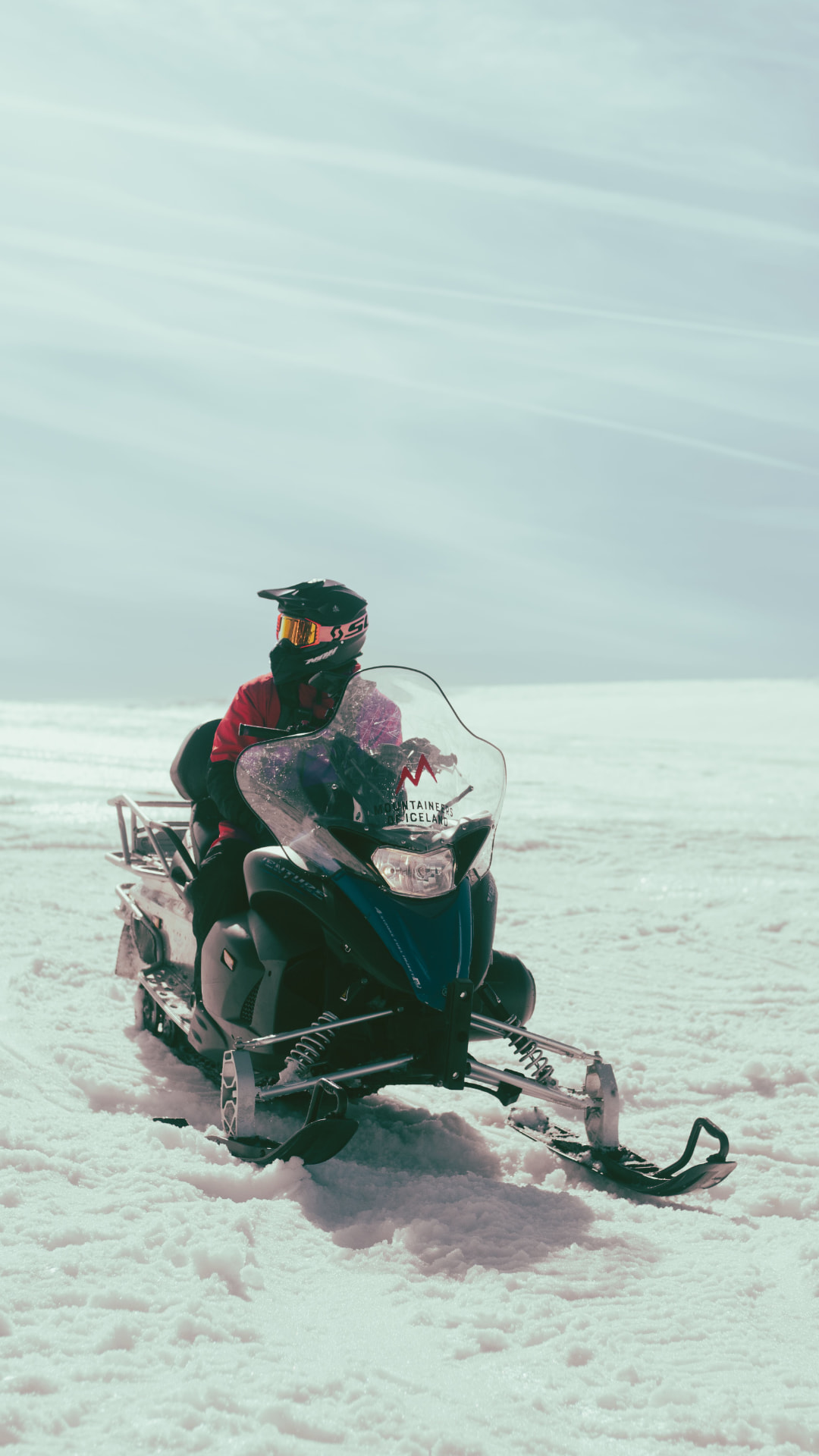 A snowmobile parked on an open snowfield