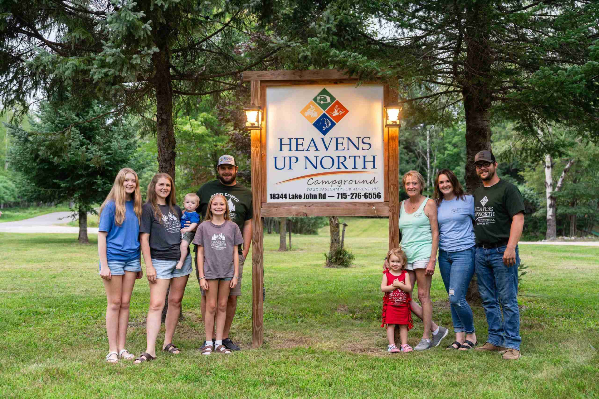 The Heaven’s Up North family beside the campground sign