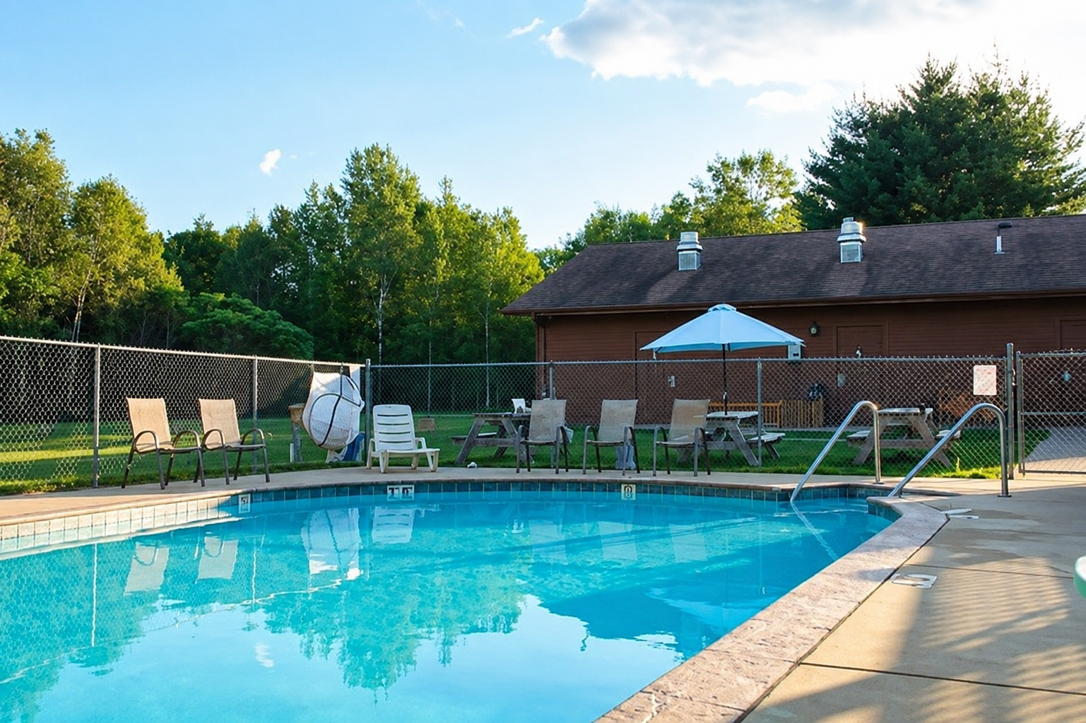 Guests enjoying the heated pool at Heaven’s Up North Campground