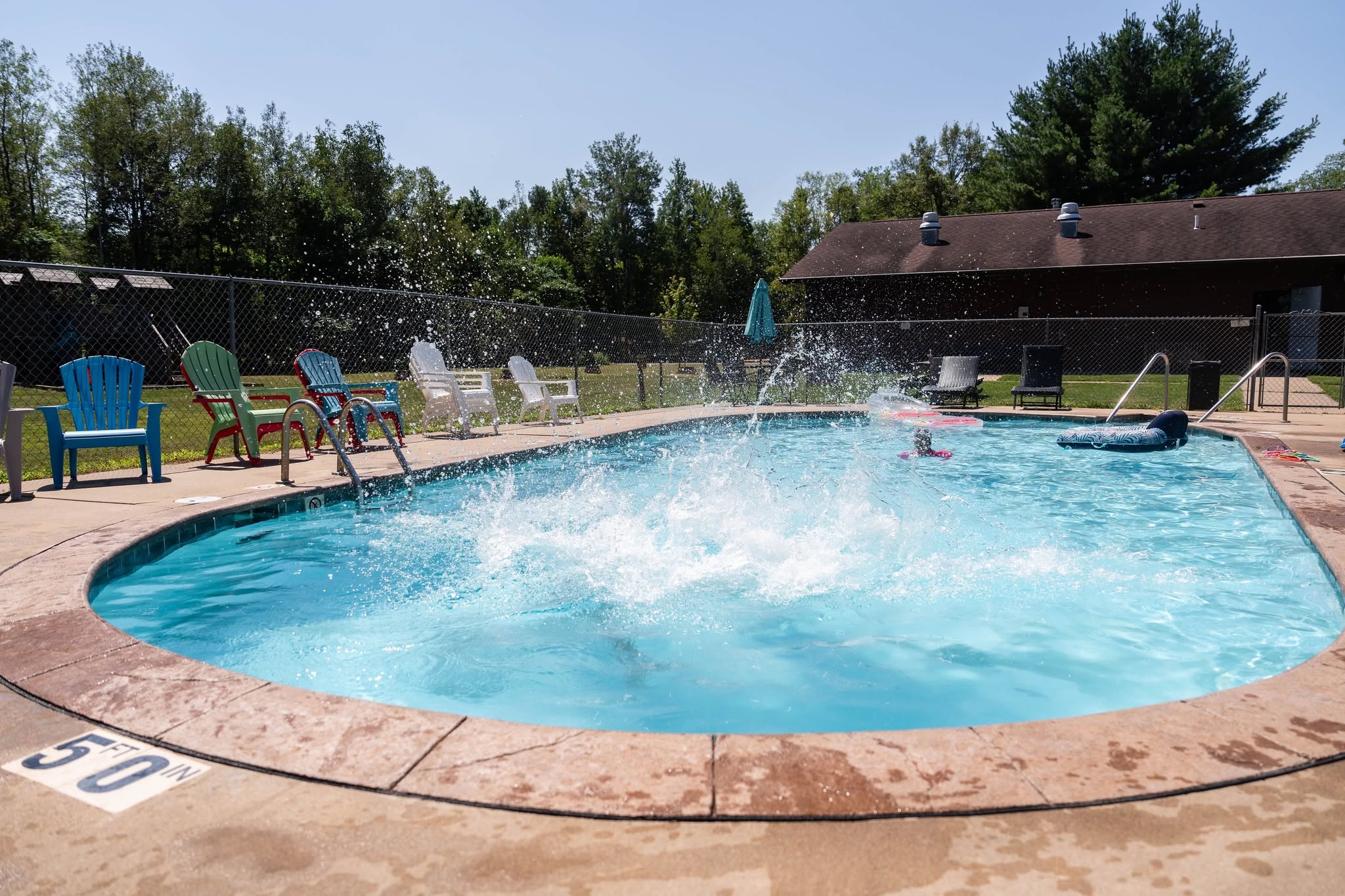 Guests enjoying the heated pool at Heaven’s Up North Campground