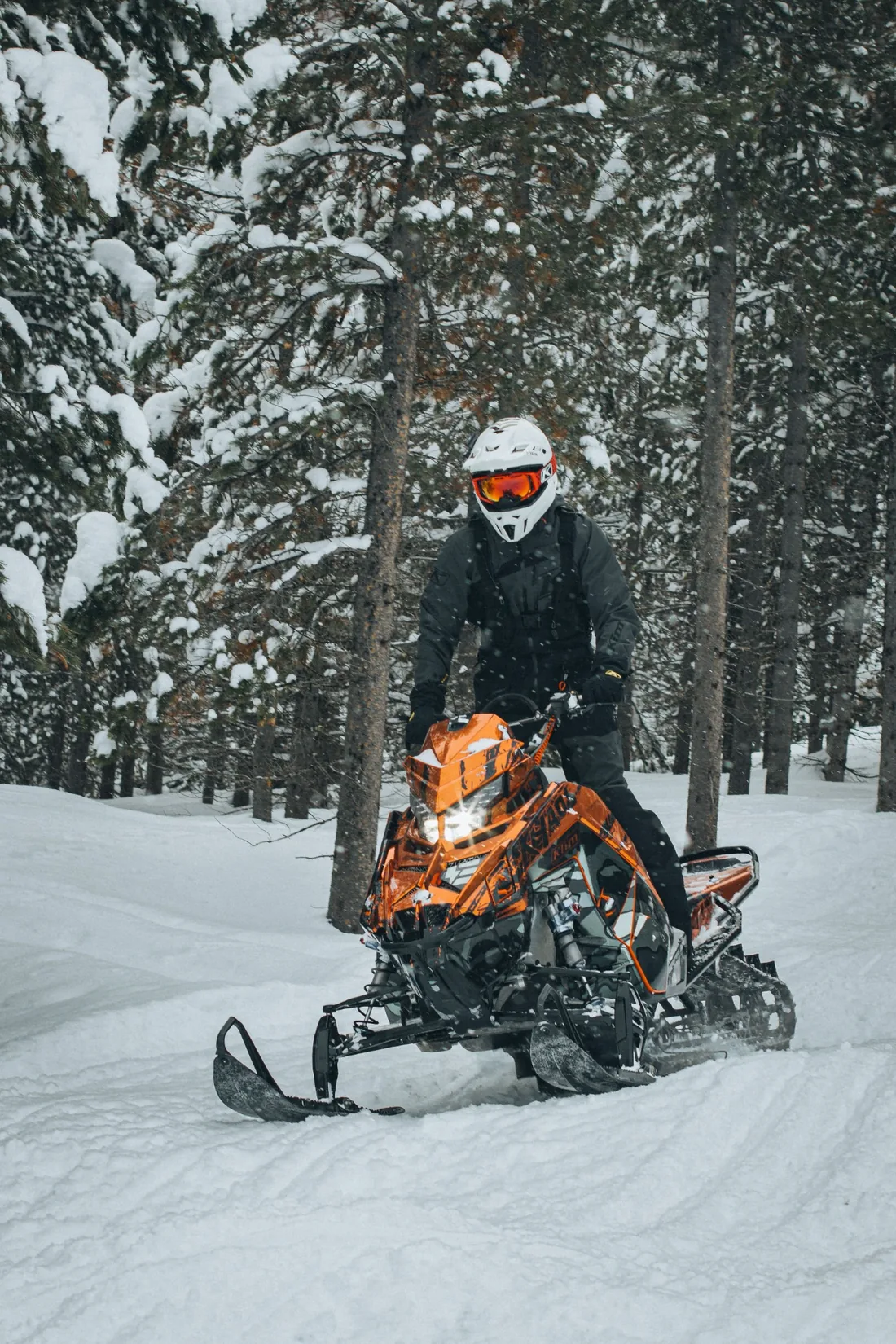 Snowmobile on a snow-covered forest trail
